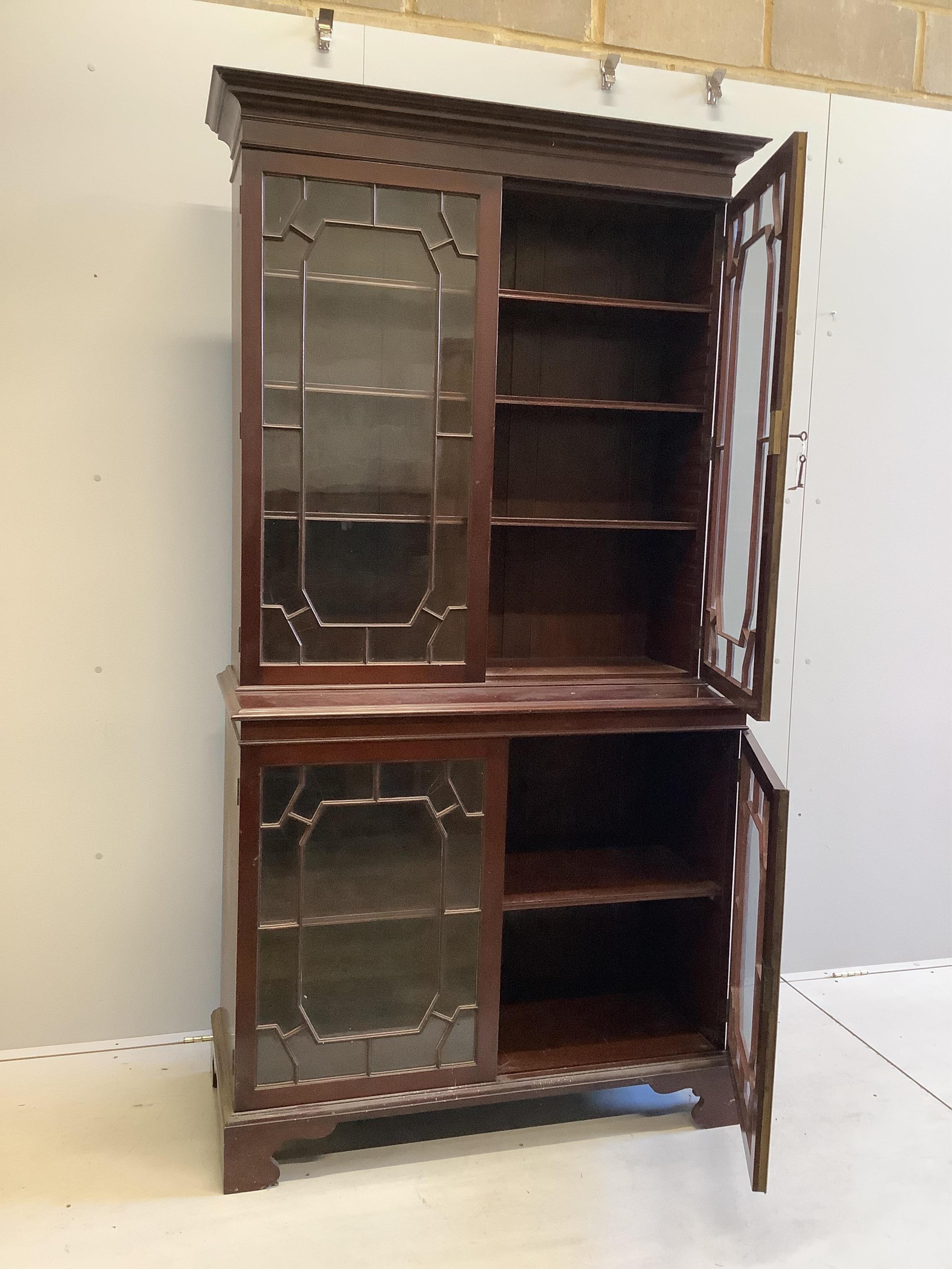 A George III style glazed mahogany bookcase, width 106cm, depth 48cm, height 206cm. Condition - fair